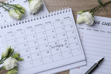 Photo of Flat lay composition with Wedding Checklist and calendars on wooden table