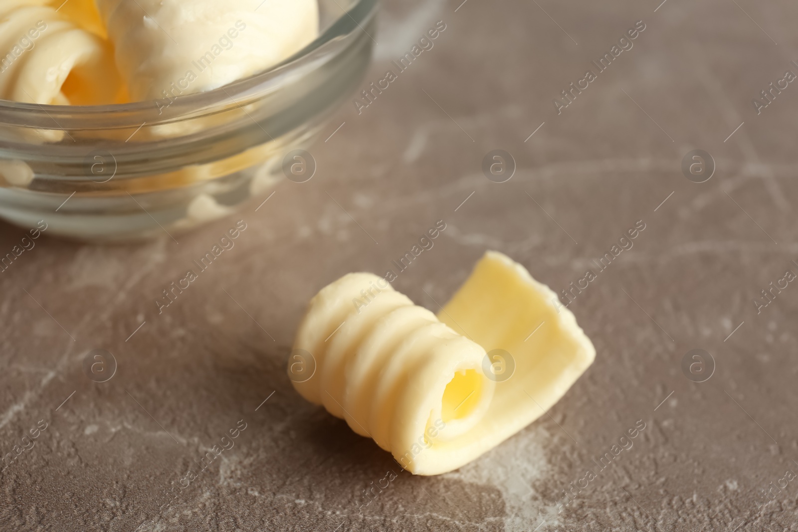 Photo of Fresh butter curl on table, closeup