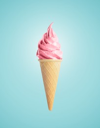 Image of Delicious soft serve berry ice cream in crispy cone on pastel light blue background