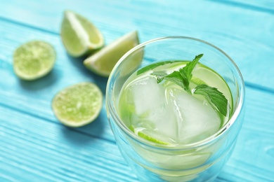 Photo of Natural lemonade with mint in glass on table, closeup