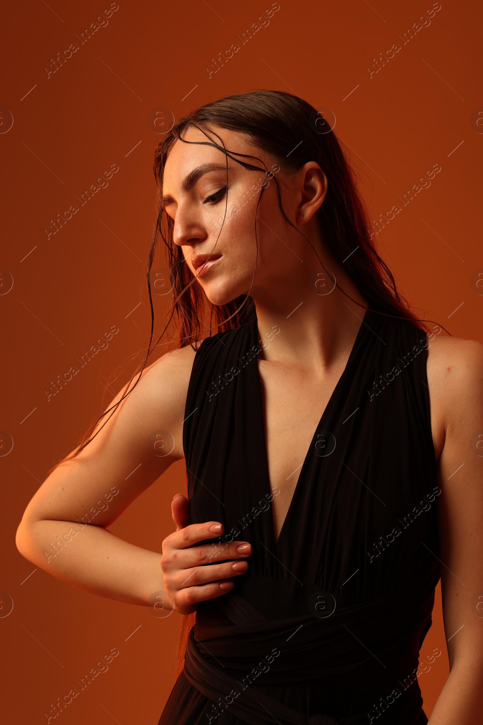 Photo of Portrait of beautiful woman on brown background