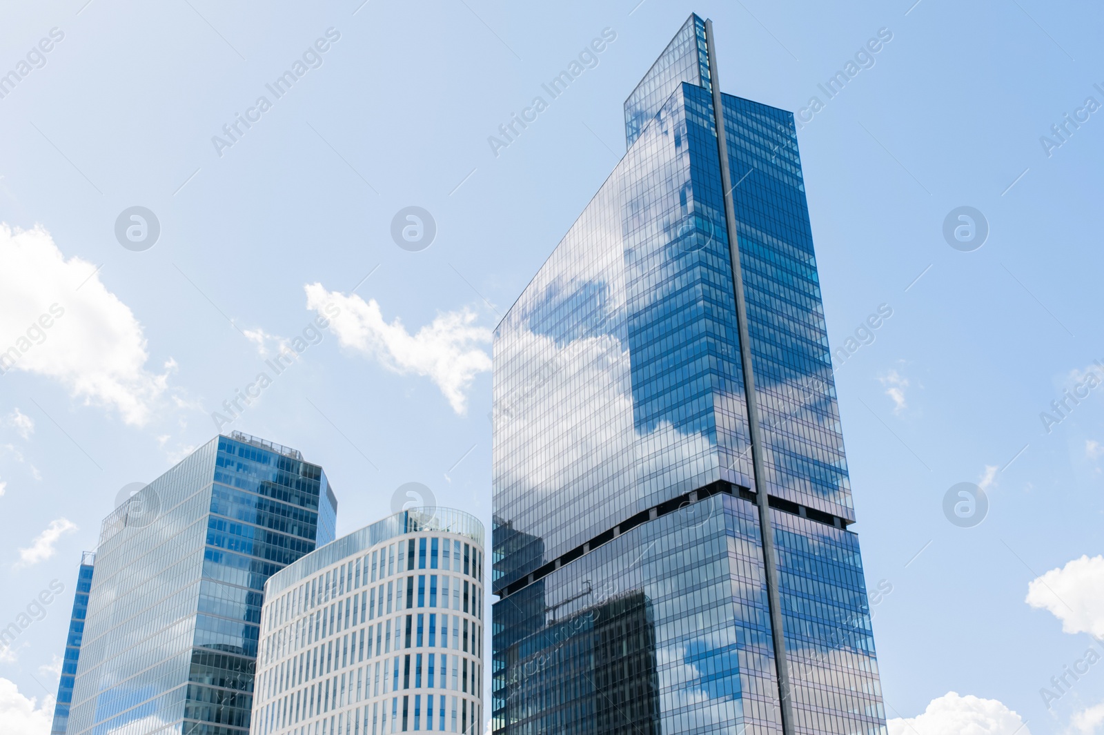 Photo of Beautiful skyscraper in city center on cloudy day. Modern architectural design