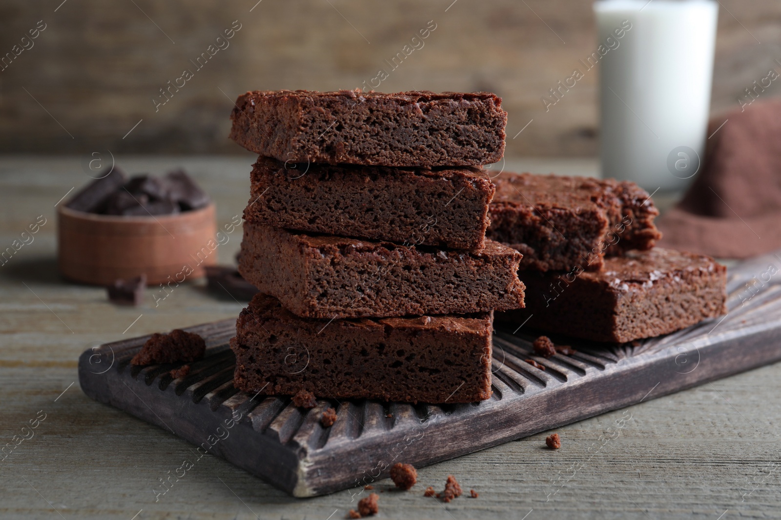 Photo of Delicious chocolate brownies on wooden table. Tasty dessert