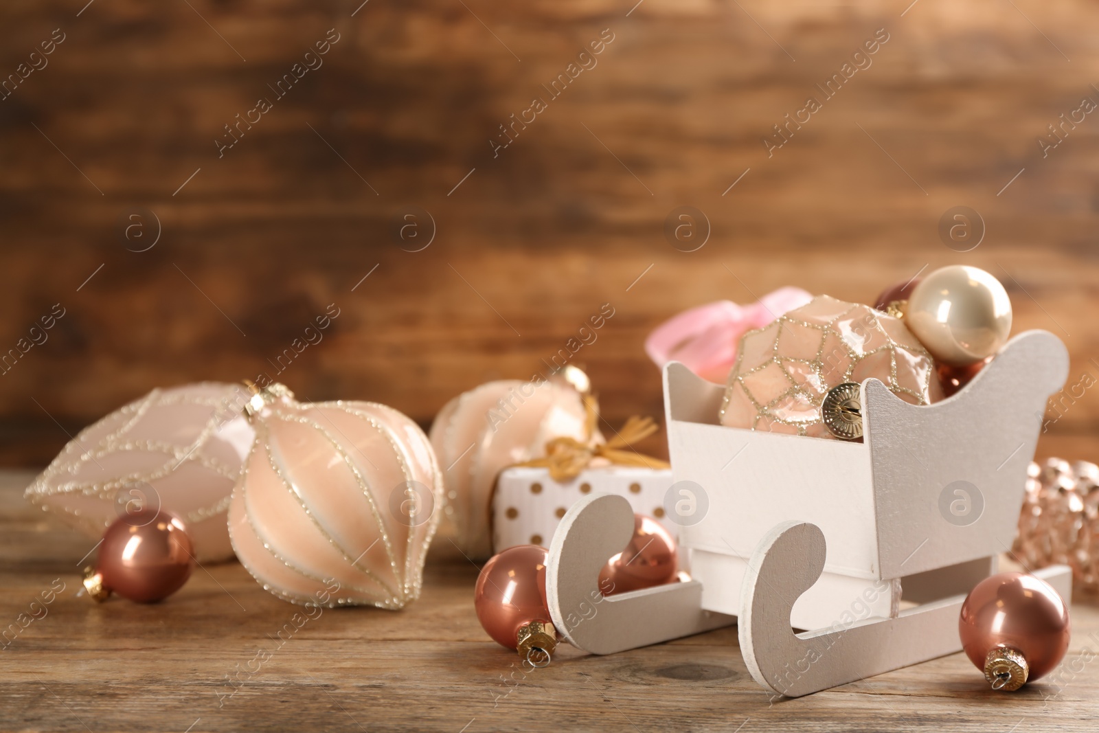 Photo of Beautiful Christmas composition with miniature sleigh on wooden table