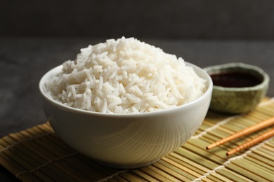 Bowl of tasty cooked rice served on table