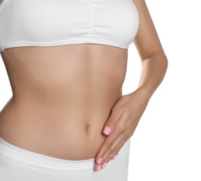 Woman in underwear touching her belly on white background, closeup. Healthy stomach