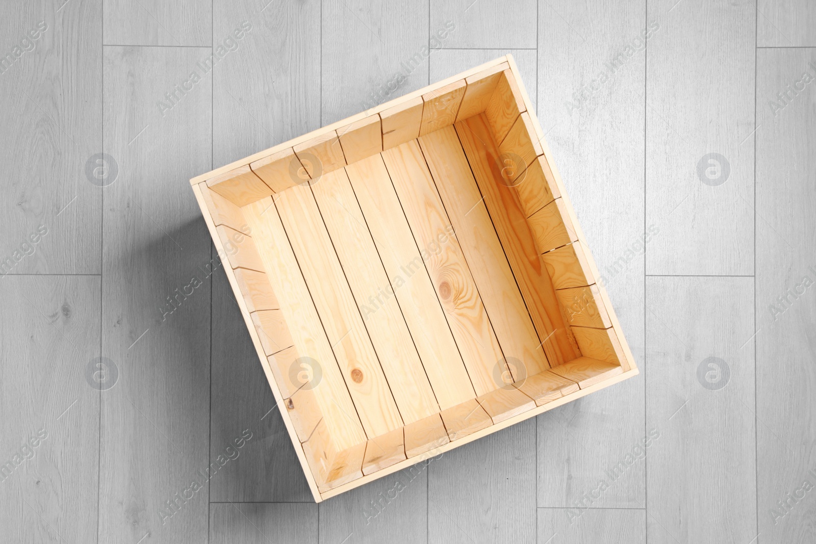 Photo of Open wooden crate on floor, top view