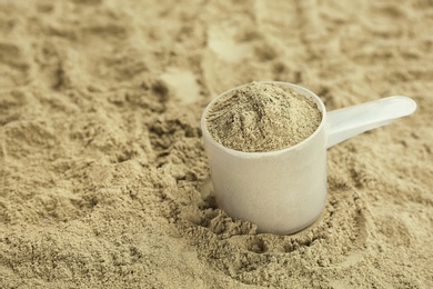 Photo of Measuring spoon and hemp protein powder, closeup. Superfood