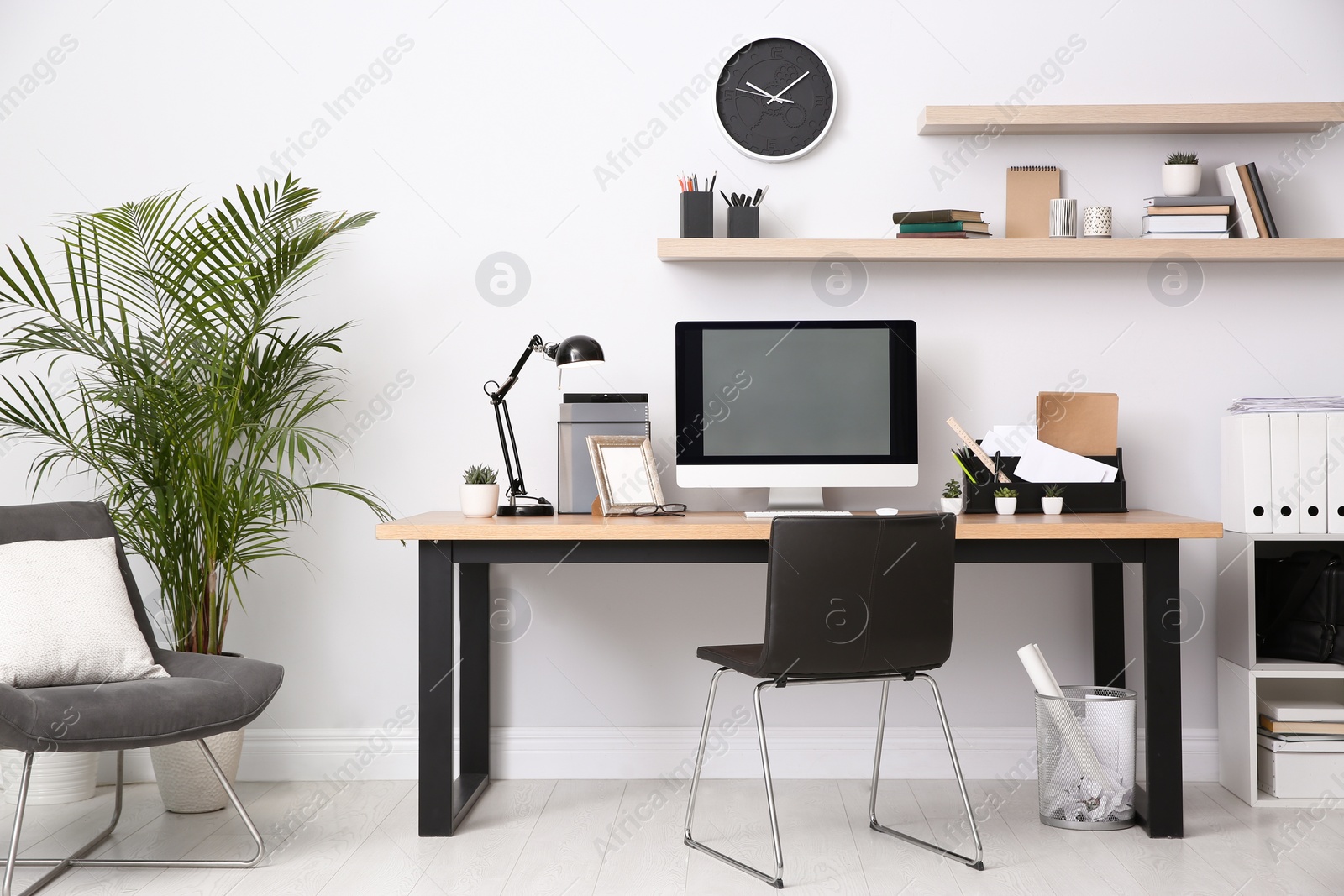 Photo of Modern computer on table in office interior. Stylish workplace