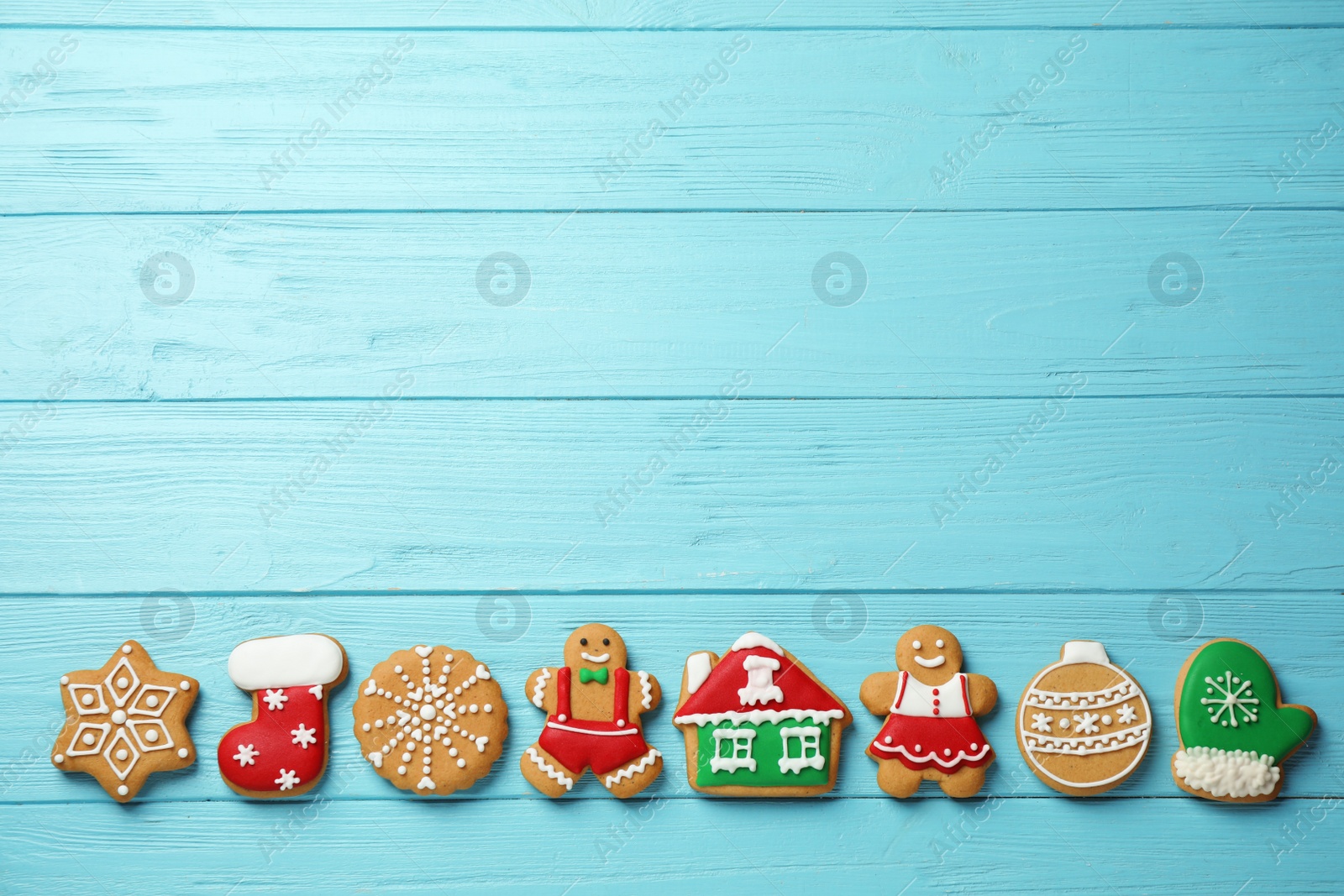 Photo of Flat lay composition with tasty homemade Christmas cookies on light blue wooden table, space for text