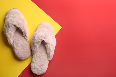 Photo of Pair of stylish soft slippers on color background, flat lay. Space for text