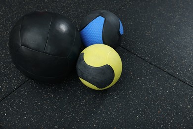 Photo of Many different medicine balls on black floor