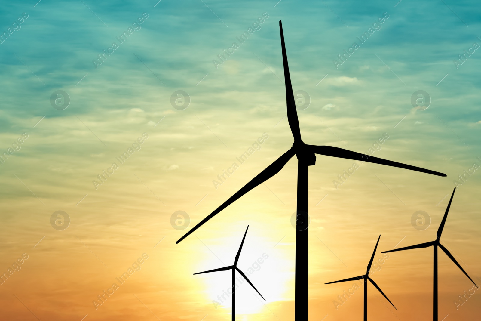 Image of Silhouettes of wind turbines at sunset. Alternative energy source