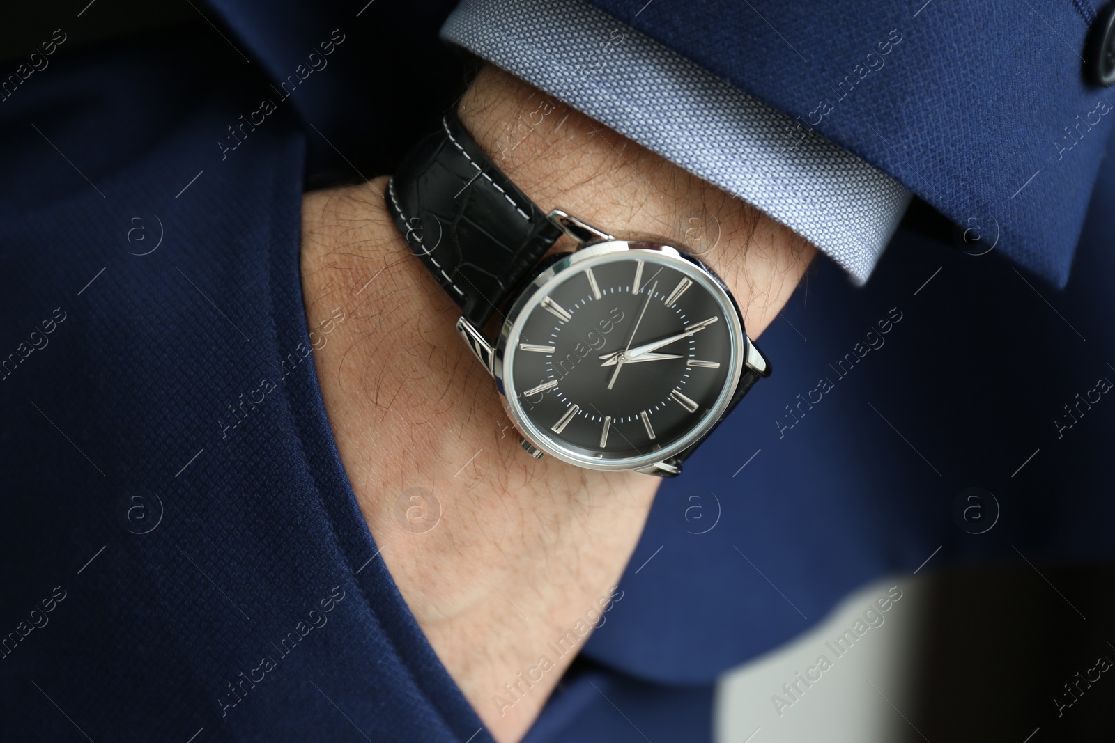 Photo of Businessman in suit with luxury wrist watch, closeup