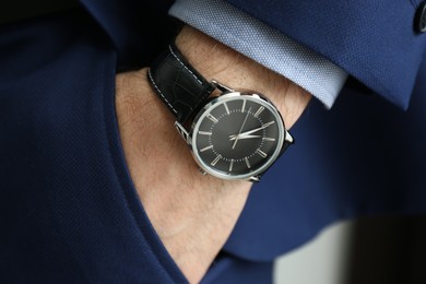 Photo of Businessman in suit with luxury wrist watch, closeup