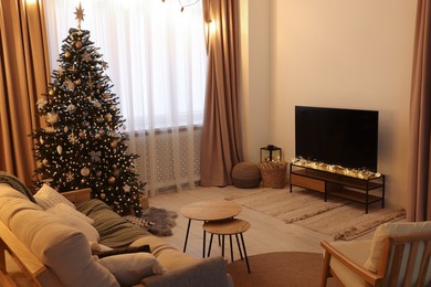 Photo of Tv, furniture and Christmas tree in stylish room