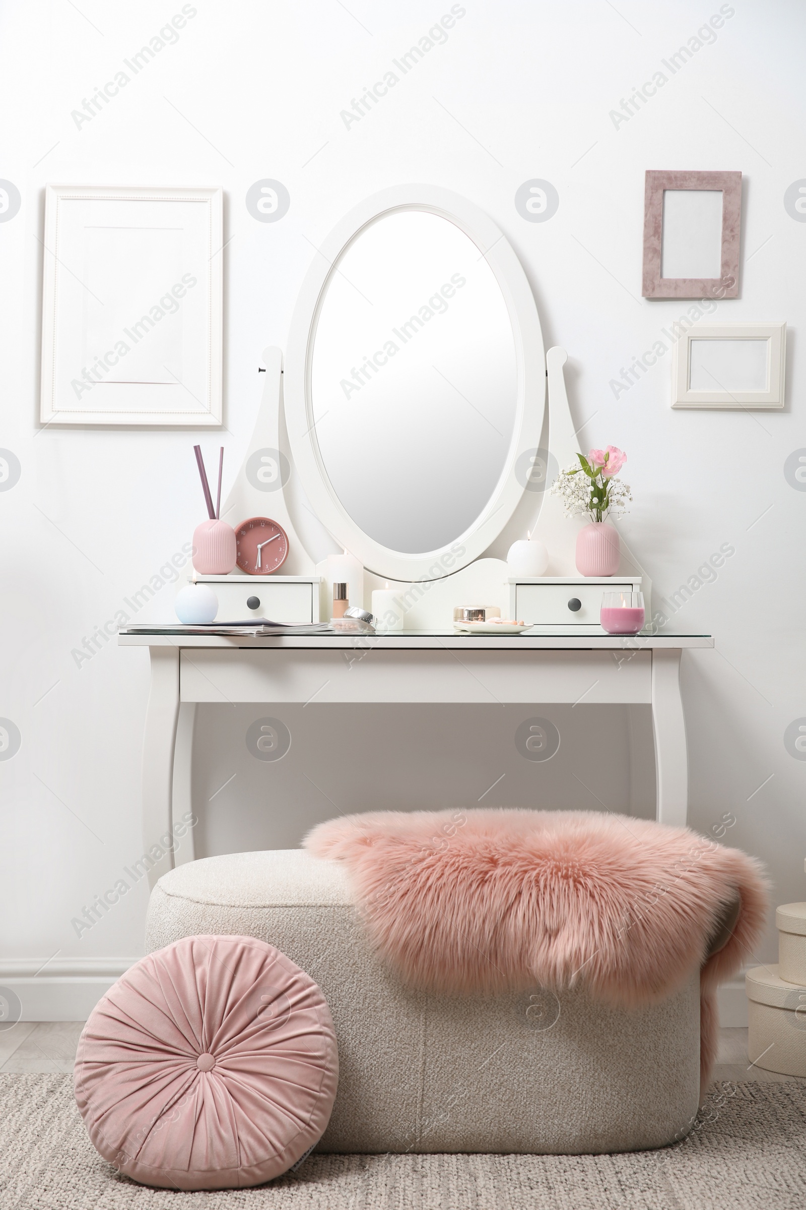 Photo of Dressing table with decor near white wall in room