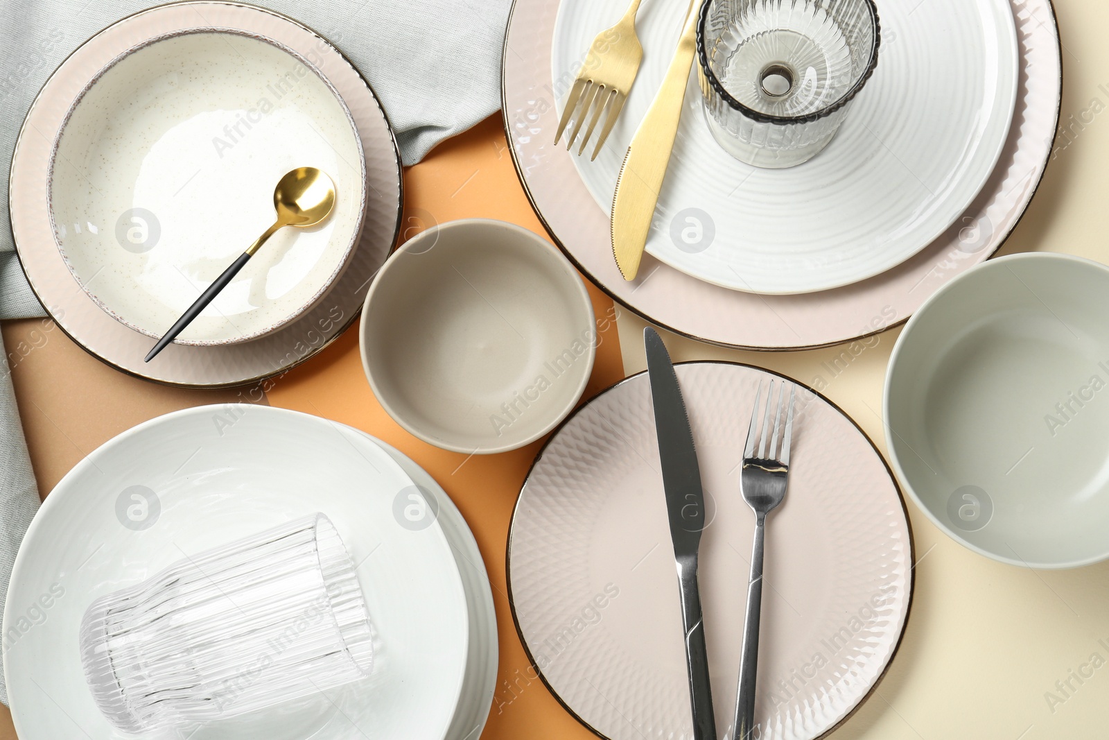 Photo of Clean plates, bowls, glasses and cutlery on table, flat lay