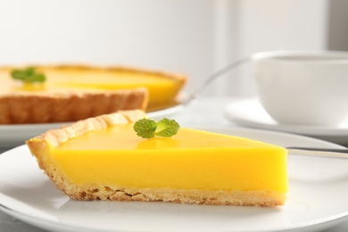 Photo of Slice of delicious homemade lemon pie on plate