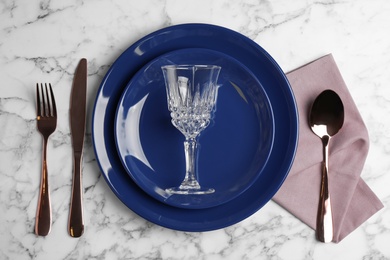 Photo of Elegant table setting on white marble background, top view