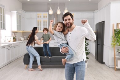 Happy family dancing and having fun at home