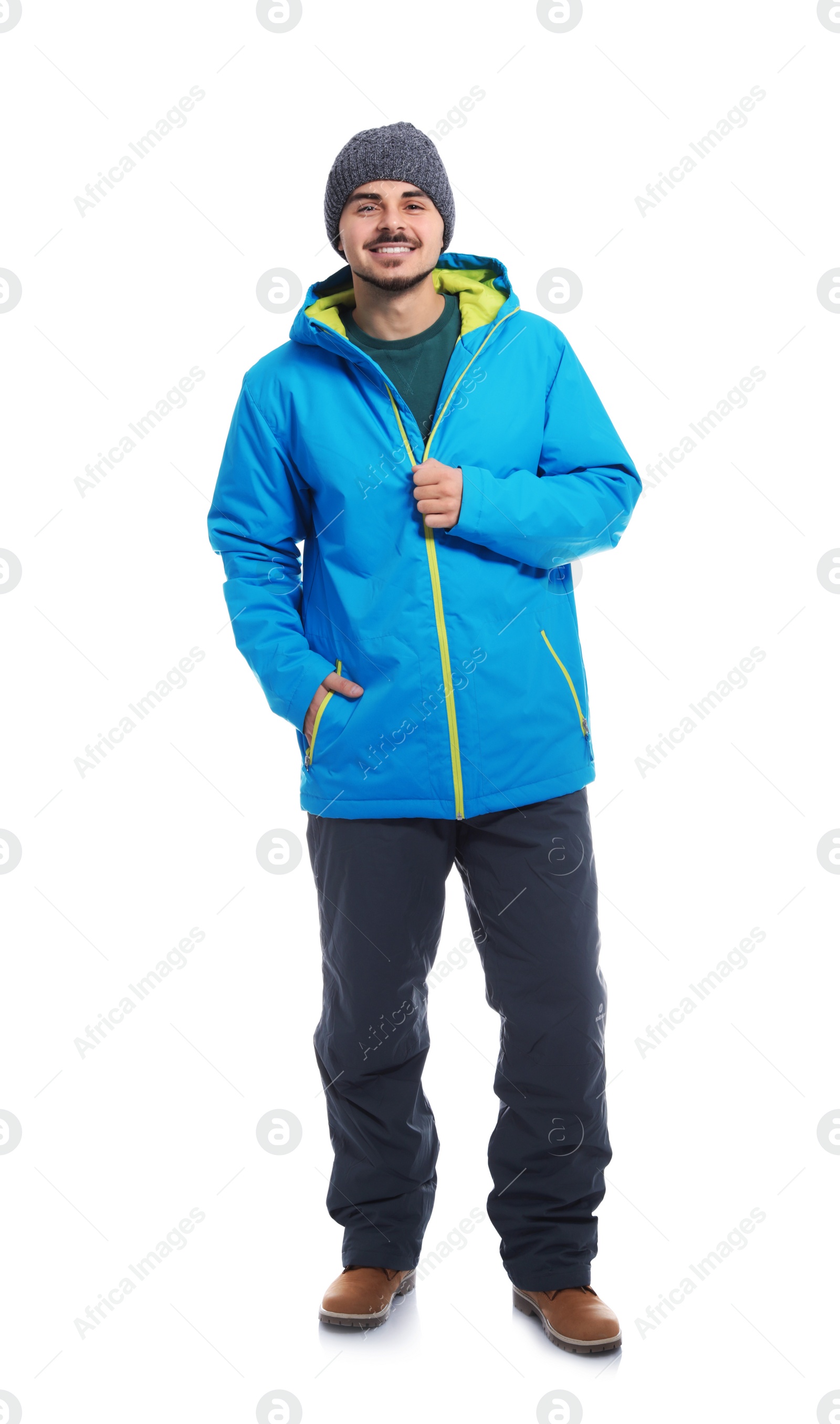 Photo of Young man wearing warm clothes on white background. Ready for winter vacation