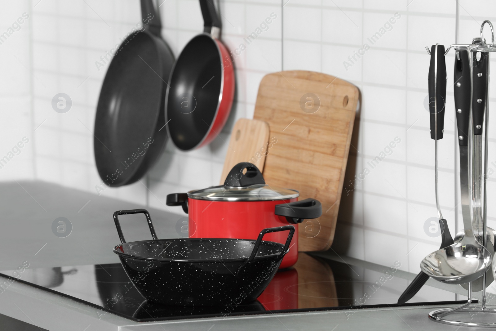 Photo of Set of clean cookware and utensils in kitchen
