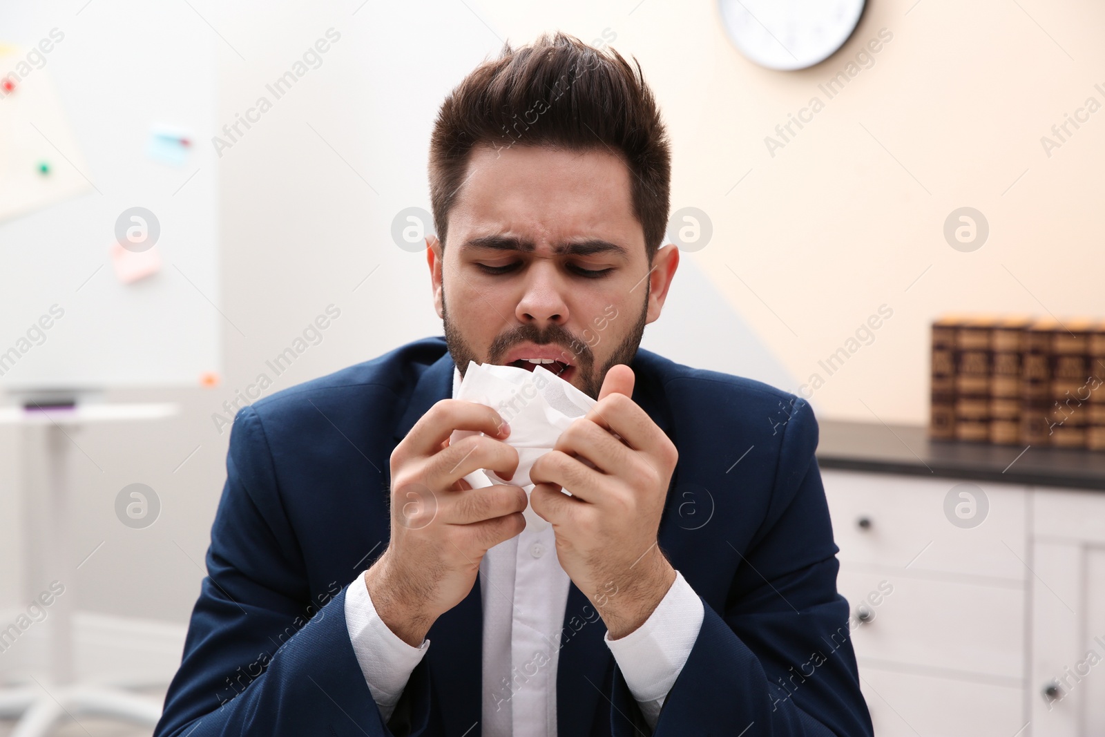 Photo of Sick young man at workplace. Influenza virus