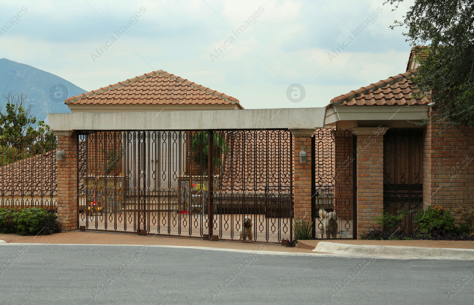 Photo of Closed metal gates near beautiful house on city street