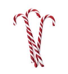 Photo of Delicious Christmas candy canes on white background, top view