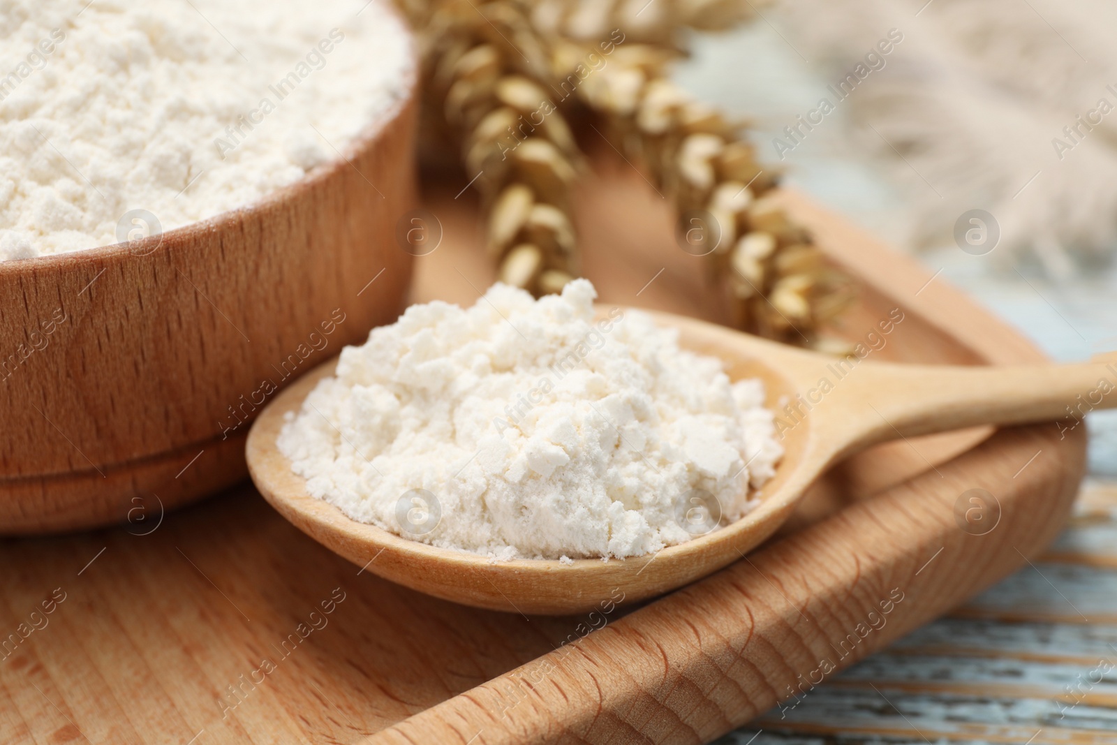 Photo of Organic wheat flour on wooden table, closeup