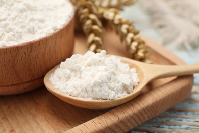 Photo of Organic wheat flour on wooden table, closeup