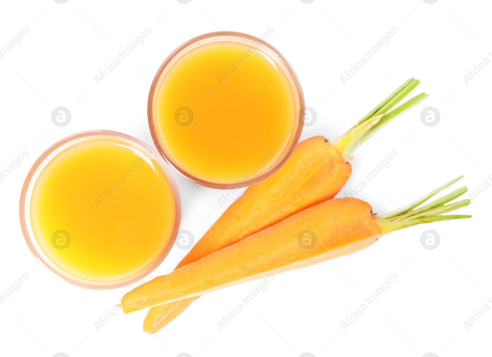 Photo of Freshly made carrot juice on white background, top view