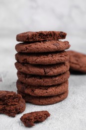 Tasty chocolate cookies on light grey table, closeup