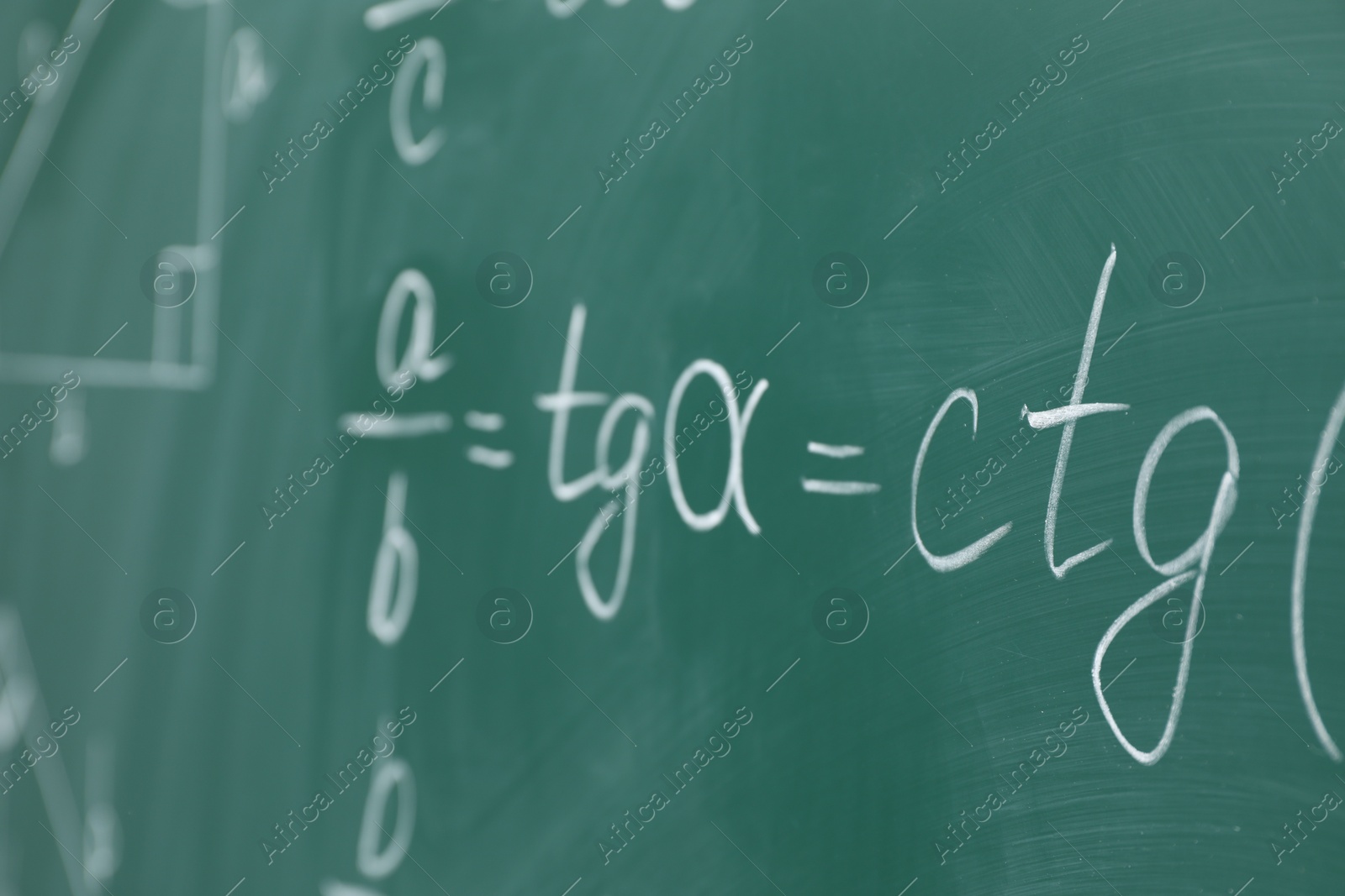 Photo of Many different math formulas written on chalkboard