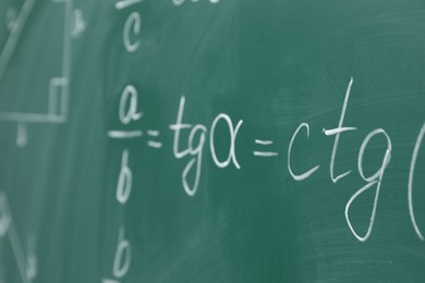 Photo of Many different math formulas written on chalkboard