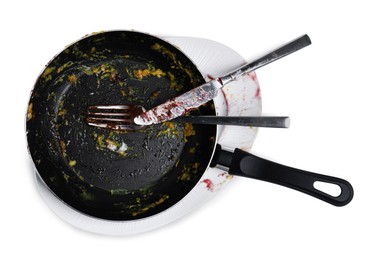 Dirty frying pan and cutlery on white background, top view