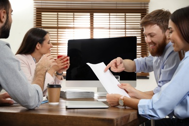 Group of colleagues using video chat on computer in office. Space for text