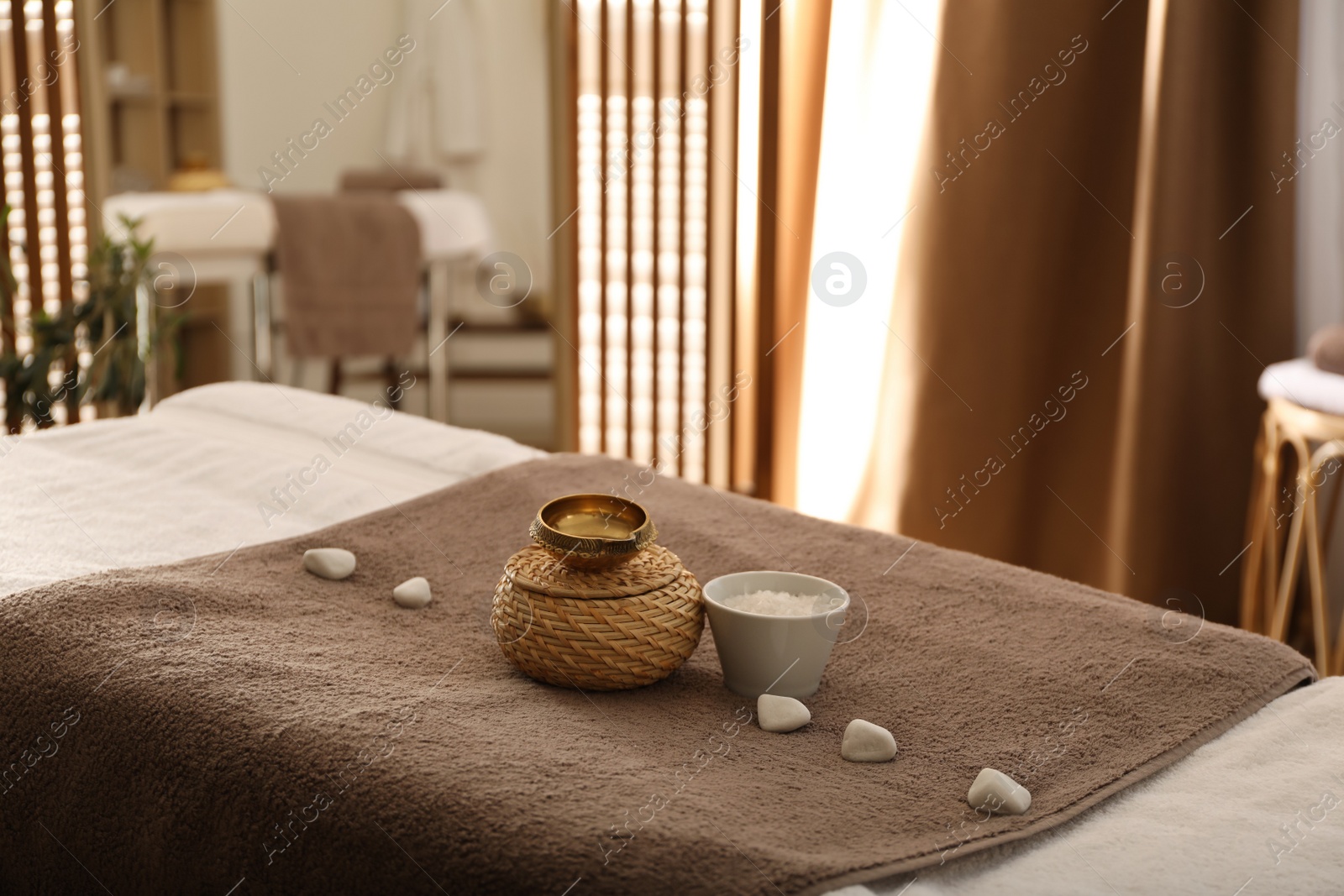 Photo of Beautiful spa composition on massage table in wellness center