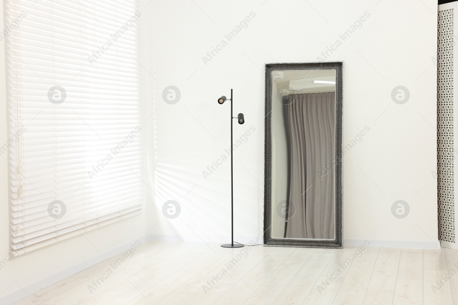 Photo of Stylish makeup room interior with long mirror and lamp. Space for text