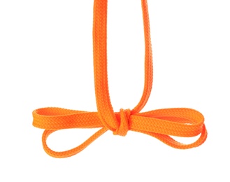 Photo of Orange shoe lace tied in bow isolated on white