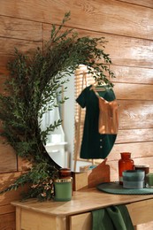 Stylish dressing table and mirror decorated with green eucalyptus in room