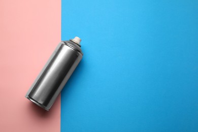 Photo of Can of spray paint on color background, top view with space for text. Graffiti supply