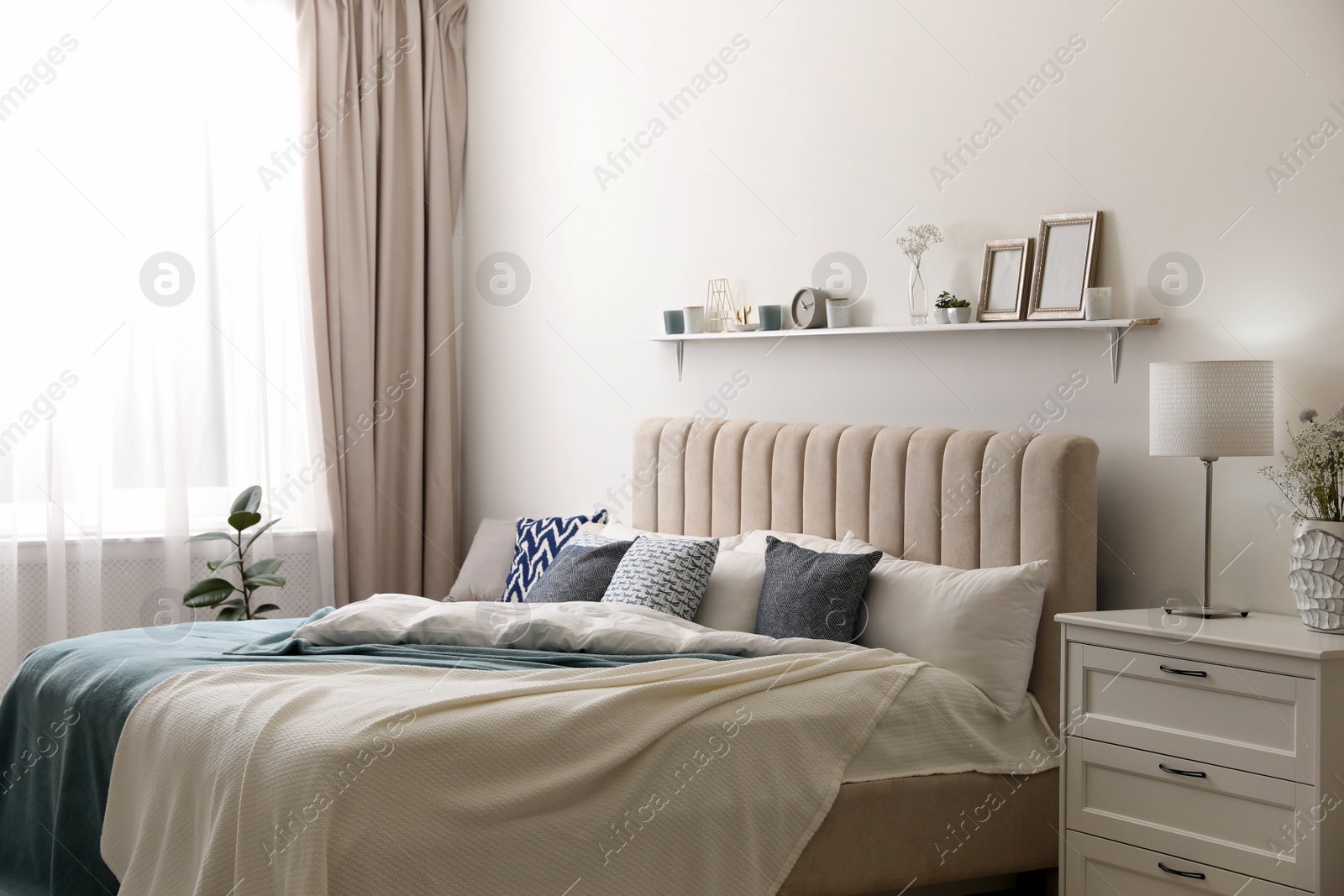 Photo of Comfortable bed with pillows in room. Stylish interior design