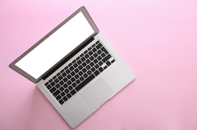 Photo of Modern laptop with blank screen on pink background, top view