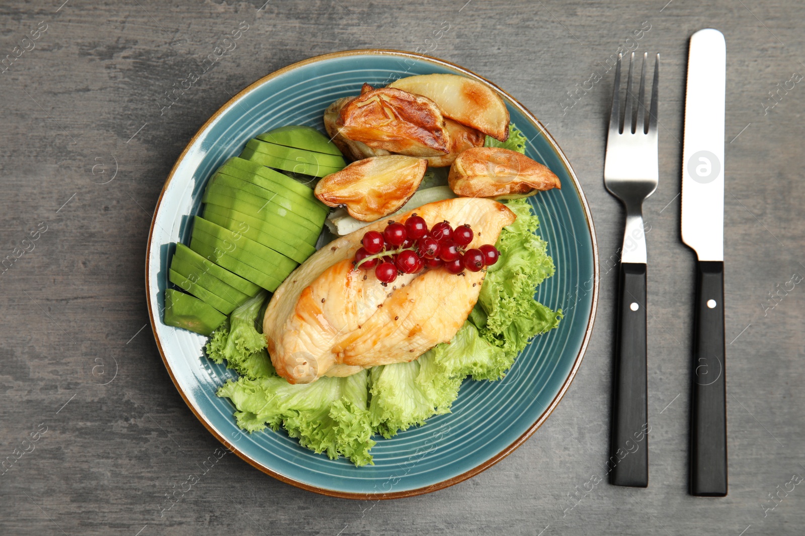 Photo of Tasty cooked chicken fillet and vegetables served on grey table, flat lay. Healthy meals from air fryer