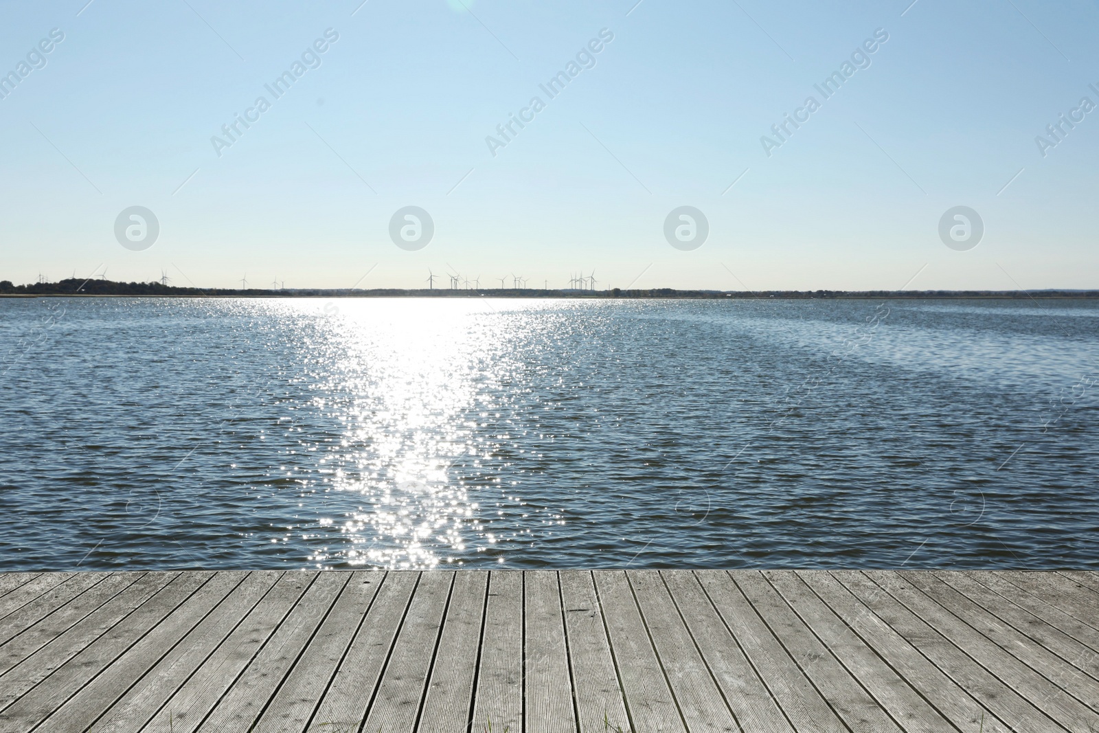 Photo of Beautiful view of wooden terrace near river on sunny day