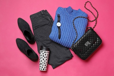 Photo of Flat lay composition with winter clothes and shoes on pink background