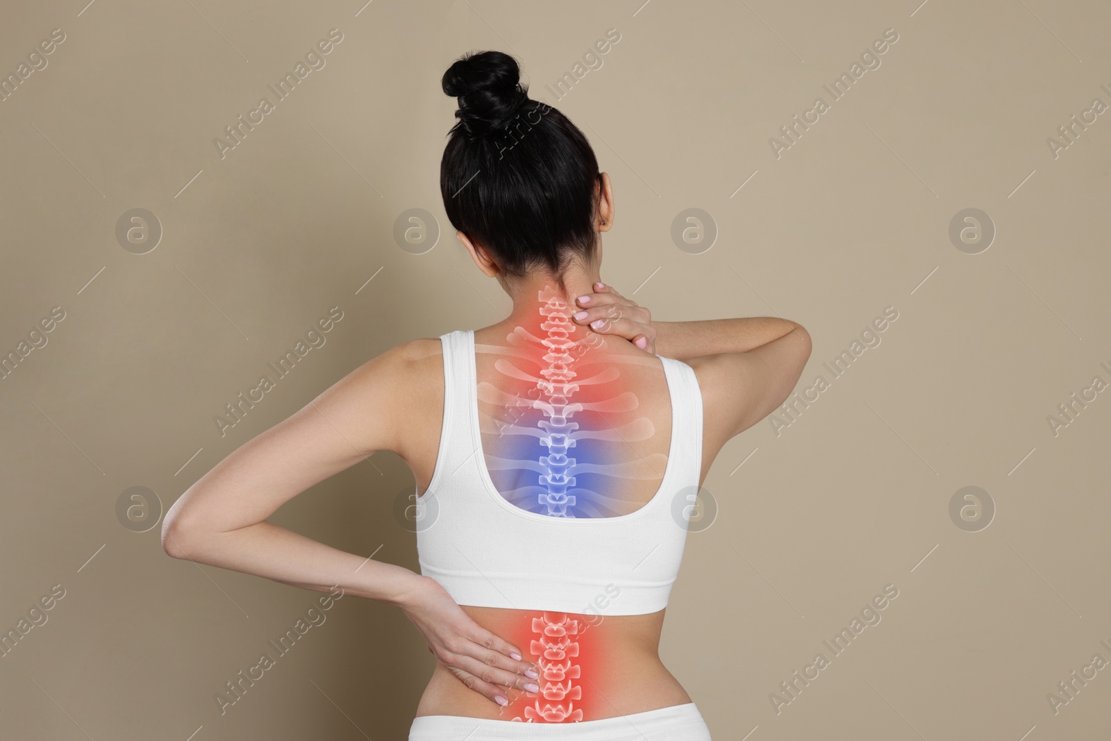 Image of Woman suffering from pain in back on beige background