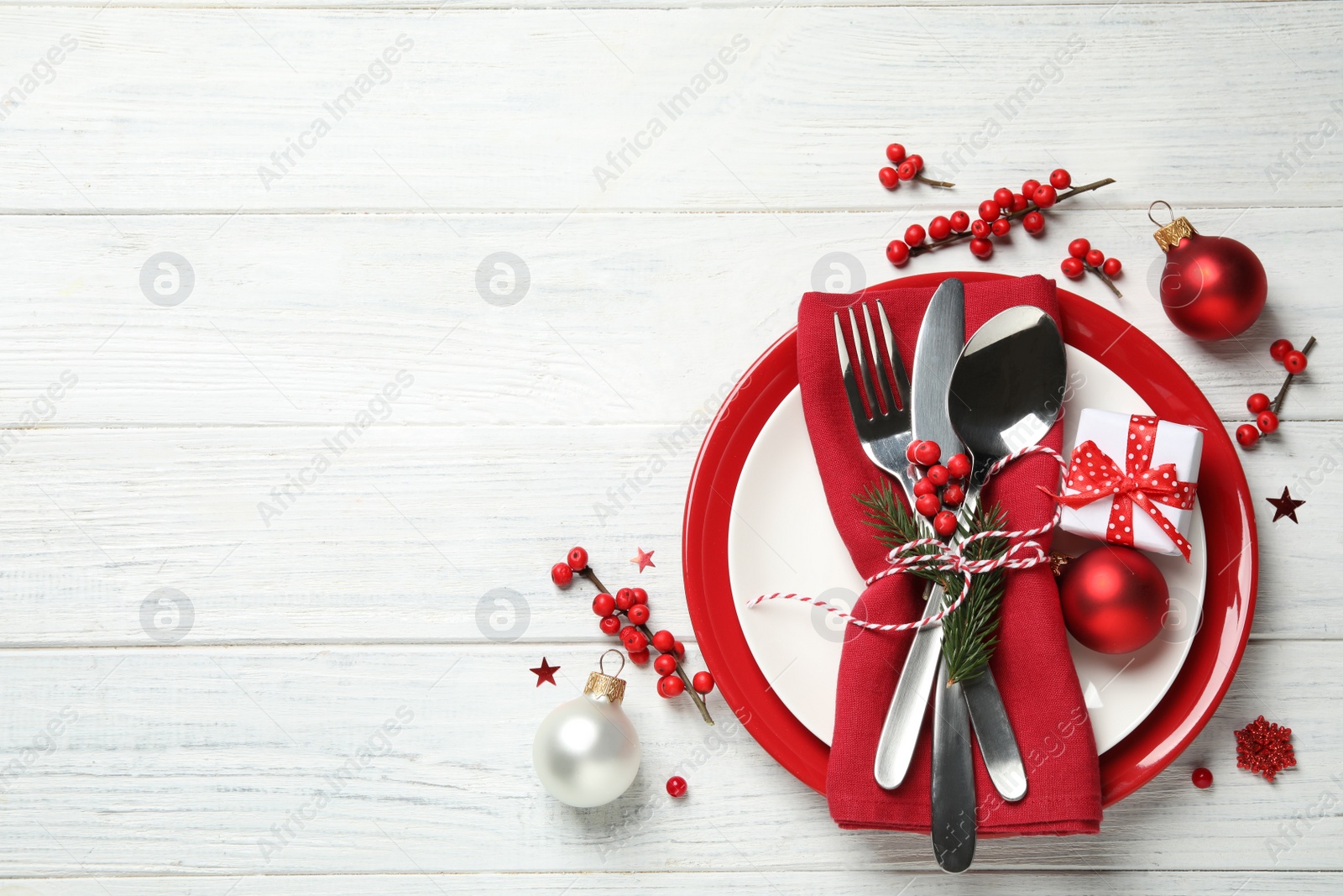 Photo of Beautiful Christmas table setting and festive decor on white wooden background, flat lay. Space for text